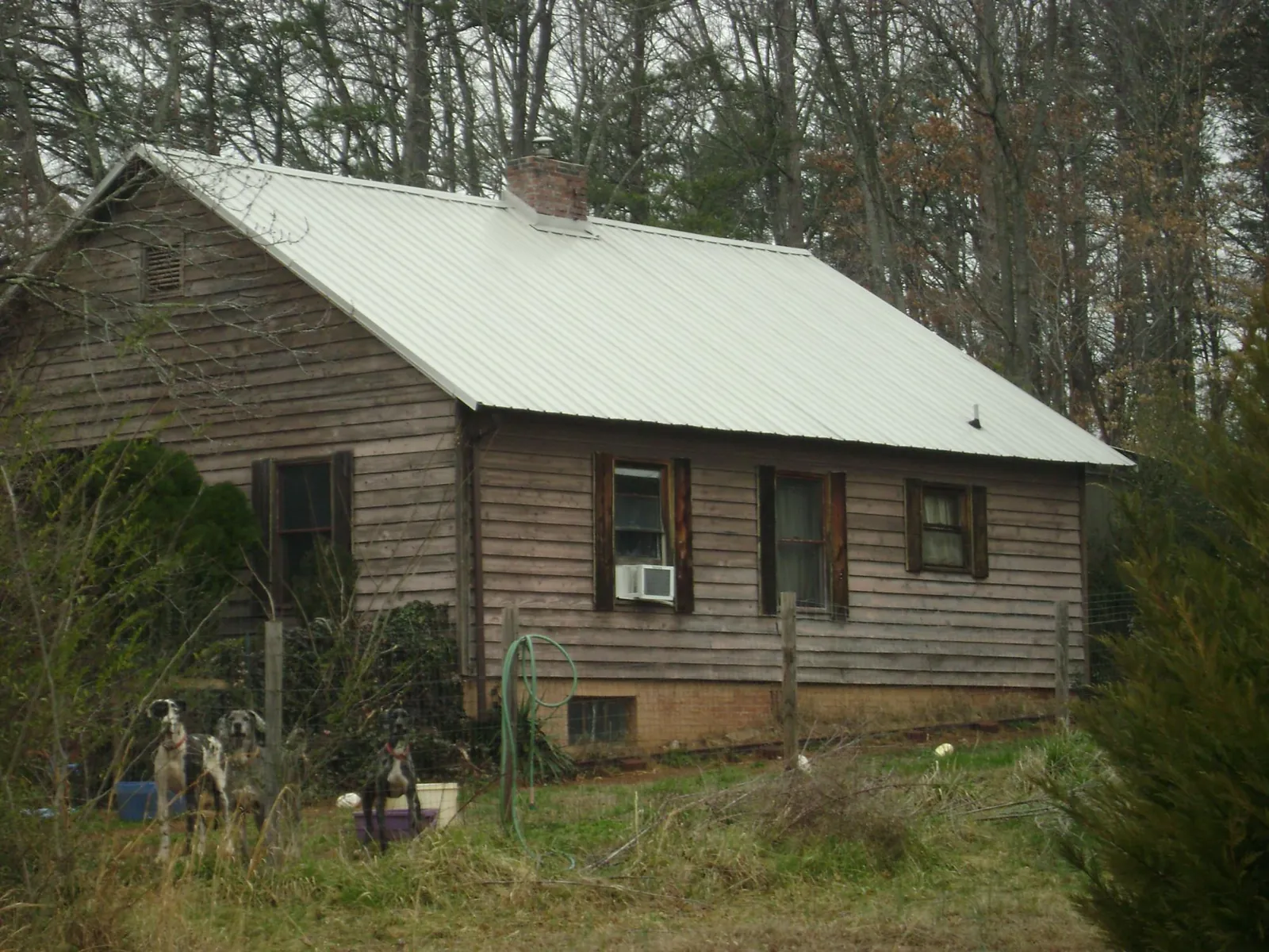 White metal roof on an old wood sided farmhouse, from a Asphalt Shingle Roof Repair job in Hillister